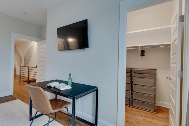 home office featuring wood finished floors and baseboards