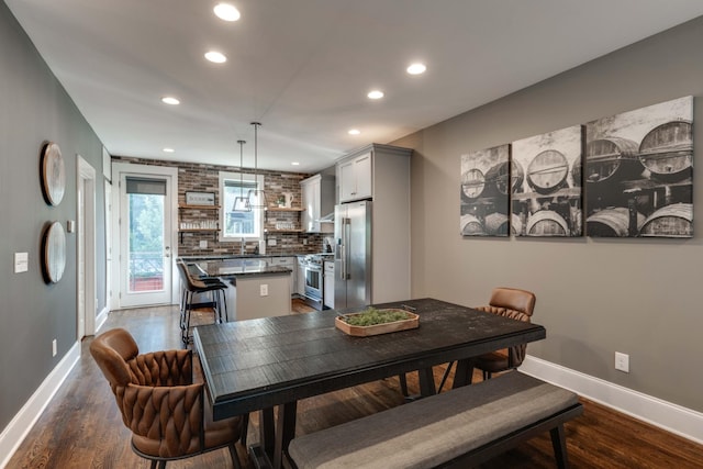 dining area featuring recessed lighting, baseboards, and dark wood-style floors