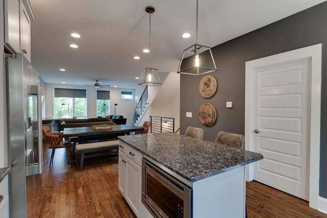 kitchen featuring appliances with stainless steel finishes, dark wood-style flooring, recessed lighting, open floor plan, and ceiling fan