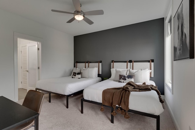 bedroom with carpet flooring, a ceiling fan, and connected bathroom