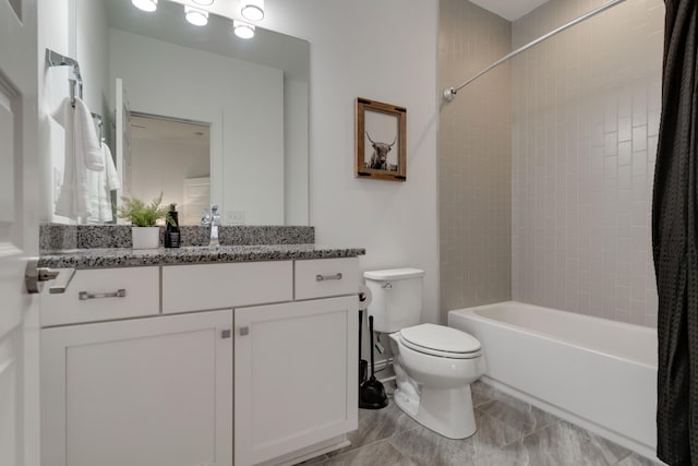 bathroom with toilet, shower / tub combo, and vanity