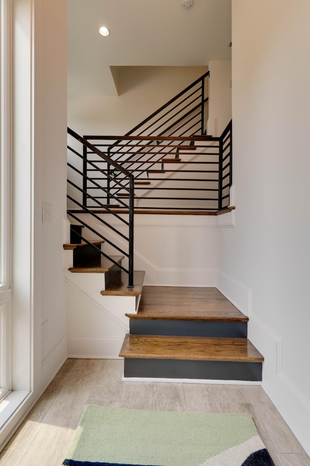 stairway featuring baseboards and recessed lighting
