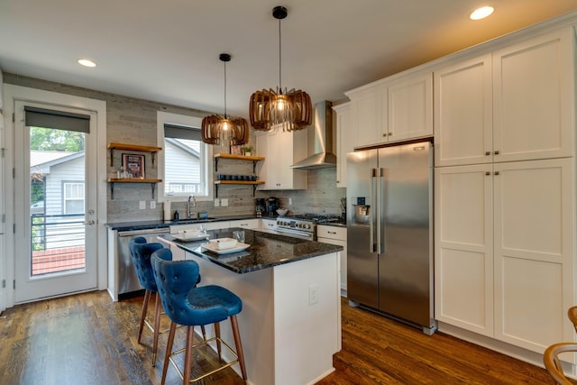 kitchen featuring premium appliances, wall chimney exhaust hood, a sink, open shelves, and dark wood-style floors
