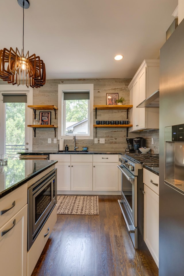 kitchen with open shelves, appliances with stainless steel finishes, a sink, decorative backsplash, and recessed lighting
