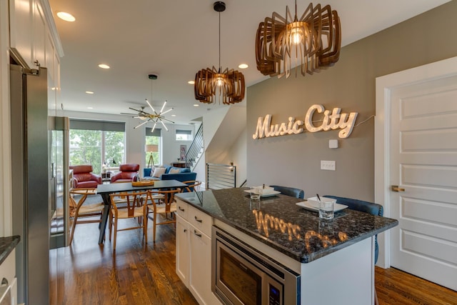 kitchen featuring stainless steel appliances, a chandelier, white cabinets, dark wood-style floors, and recessed lighting