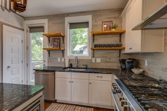 kitchen with open shelves, a sink, stainless steel appliances, tasteful backsplash, and white cabinetry