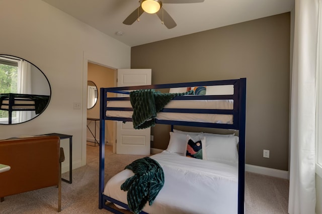 carpeted bedroom featuring baseboards and a ceiling fan