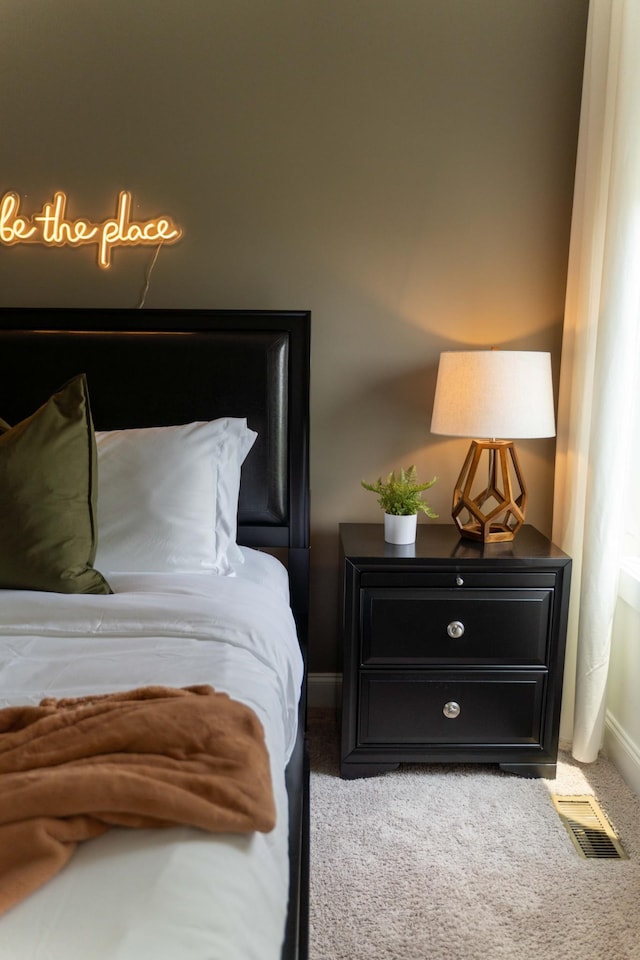 carpeted bedroom featuring baseboards
