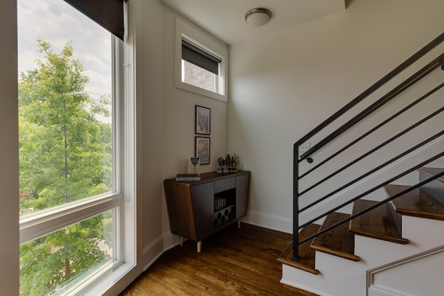 entryway featuring stairway, wood finished floors, and baseboards