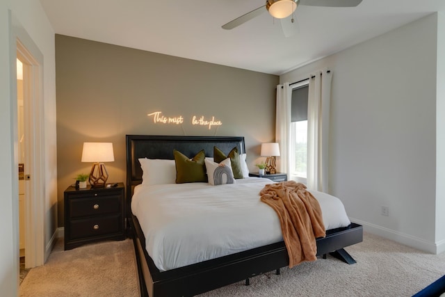 carpeted bedroom featuring baseboards and ceiling fan