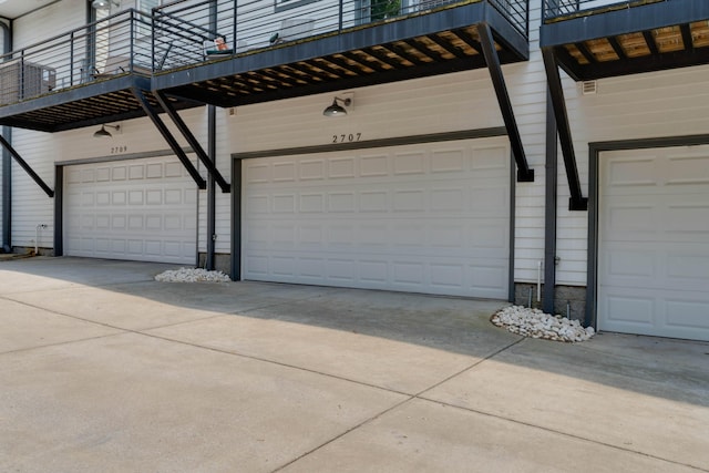 garage featuring concrete driveway