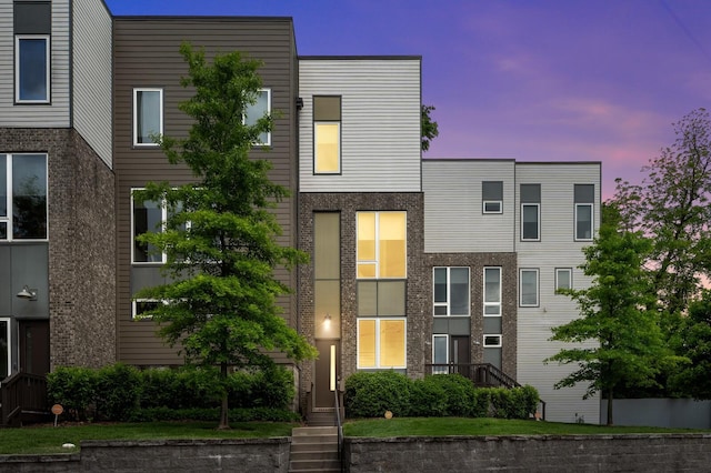 view of front of property featuring brick siding