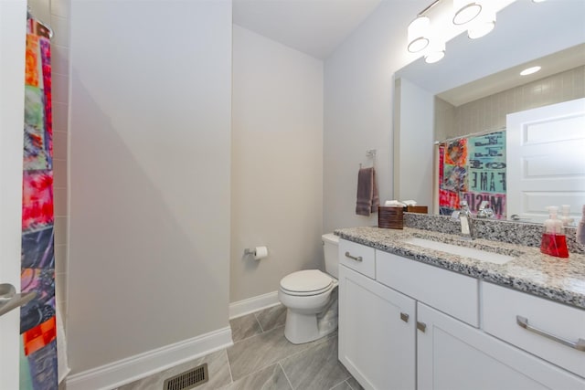 bathroom featuring baseboards, toilet, vanity, curtained shower, and tile patterned floors