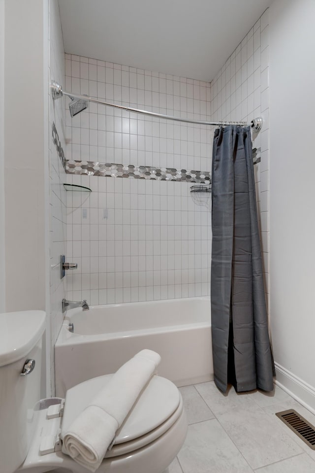 bathroom with toilet, shower / bath combo with shower curtain, and tile patterned floors