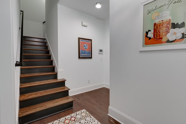 stairs with baseboards, wood finished floors, and recessed lighting