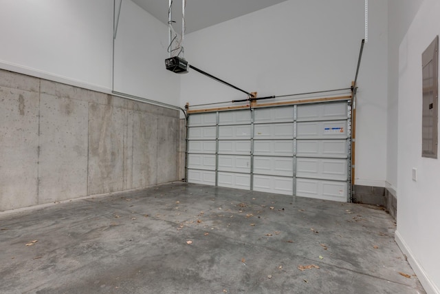 garage with a garage door opener and baseboards