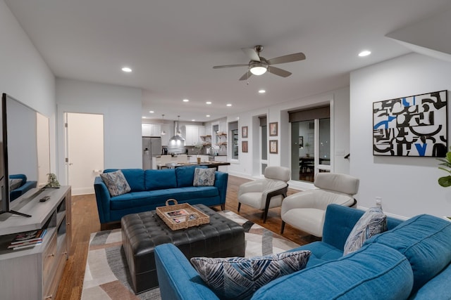 living area featuring recessed lighting, ceiling fan, and light wood finished floors