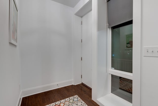 empty room featuring dark wood-style flooring and baseboards