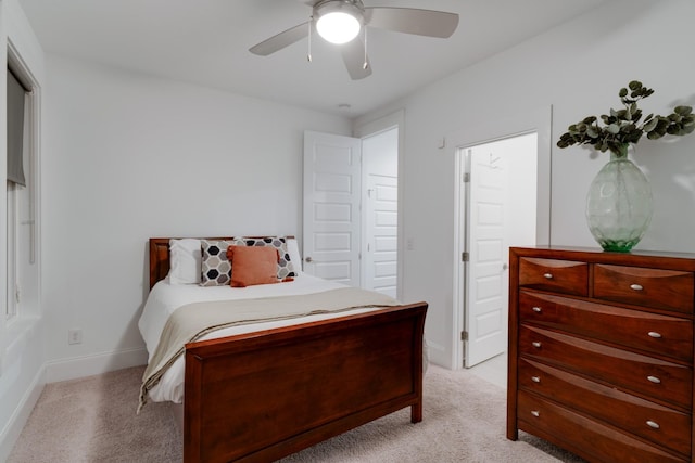 bedroom featuring light carpet, baseboards, and ceiling fan
