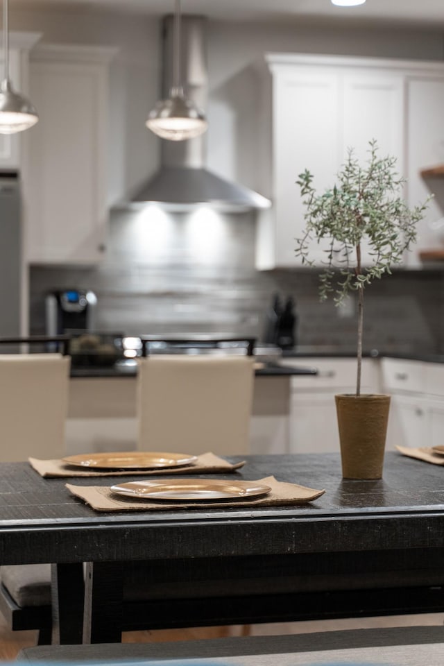 detailed view of wall chimney range hood and tasteful backsplash