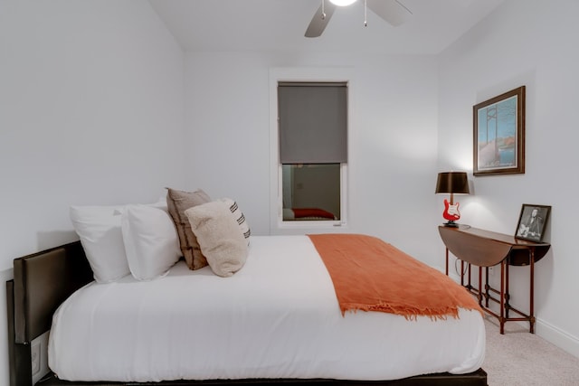 carpeted bedroom with baseboards and a ceiling fan