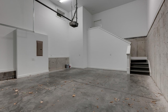 garage featuring electric panel and a garage door opener