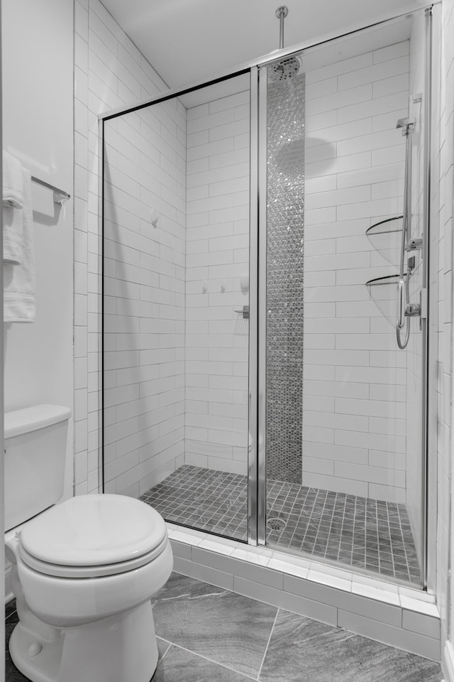 full bath with toilet and a stall shower