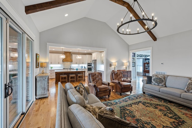7480 Horn Tavern Rd, Fairview, TN 37062 - living area with high vaulted ceiling, a chandelier, light wood-style floors, plenty of natural light, and beam ceiling