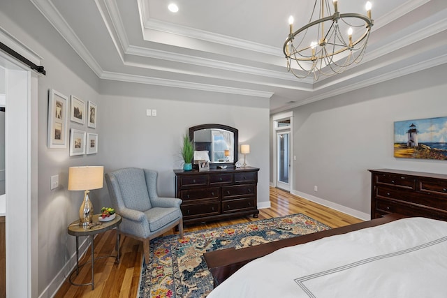 7480 Horn Tavern Rd, Fairview, TN 37062 - bedroom with a tray ceiling, wood finished floors, a chandelier, baseboards, and ornamental molding