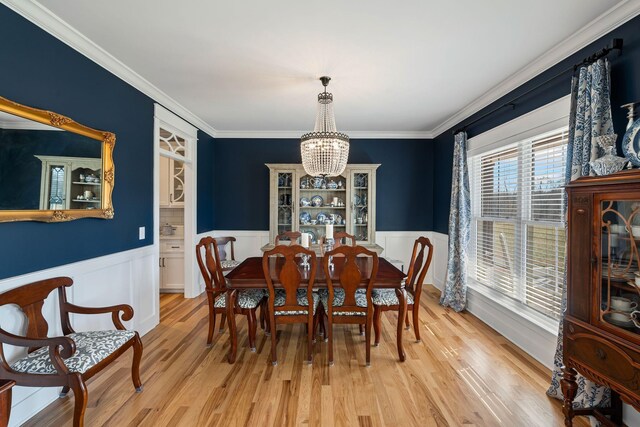 7480 Horn Tavern Rd, Fairview, TN 37062 - dining room with a chandelier, wainscoting, ornamental molding, and light wood-style flooring