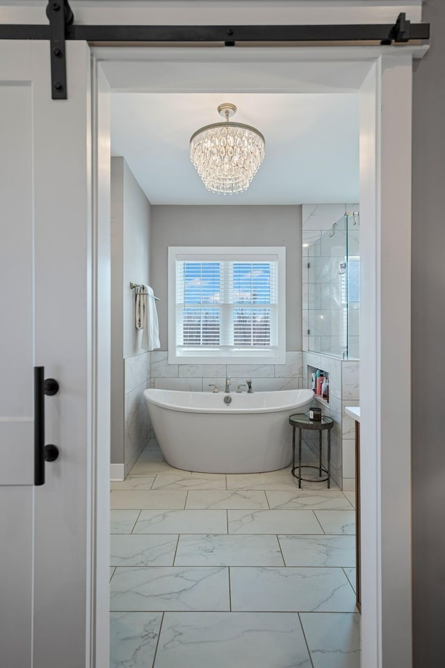 7480 Horn Tavern Rd, Fairview, TN 37062 - bathroom with a freestanding bath, marble look tiles, tile walls, a chandelier, and a tile shower