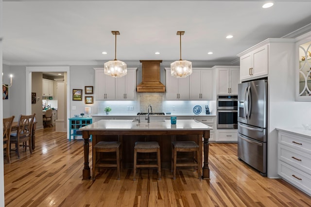 7480 Horn Tavern Rd, Fairview, TN 37062 - kitchen with appliances with stainless steel finishes, custom exhaust hood, a kitchen breakfast bar, decorative backsplash, and crown molding