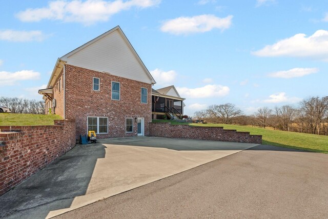 7480 Horn Tavern Rd, Fairview, TN 37062 - view of side of property featuring brick siding and a patio