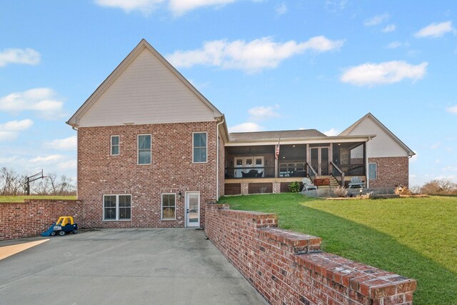 7480 Horn Tavern Rd, Fairview, TN 37062 - rear view of property with a sunroom, brick siding, a yard, and a patio area