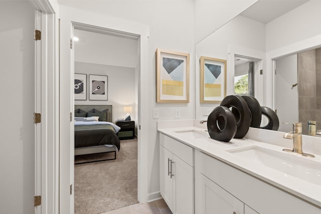 ensuite bathroom with double vanity and tile patterned floors