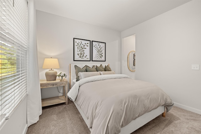 bedroom with carpet floors and baseboards