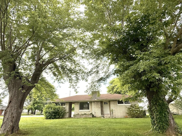 view of front facade with a front yard and brick siding