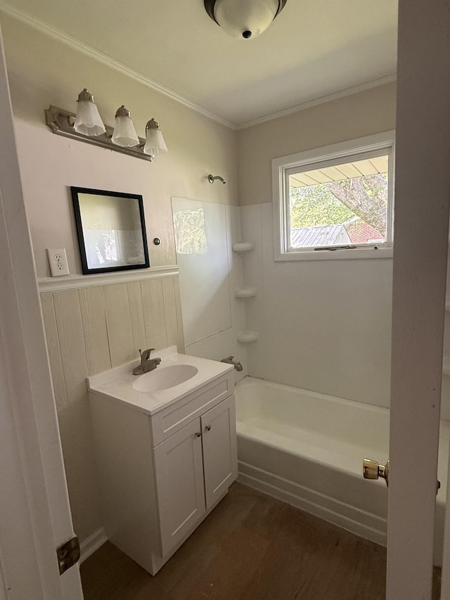 full bathroom with shower / tub combination, vanity, wood finished floors, and crown molding