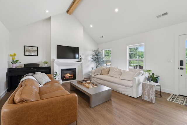 4588 Roy Thompson Rd, Mount Pleasant, TN 38474 - living room featuring a glass covered fireplace, beam ceiling, wood finished floors, high vaulted ceiling, and recessed lighting