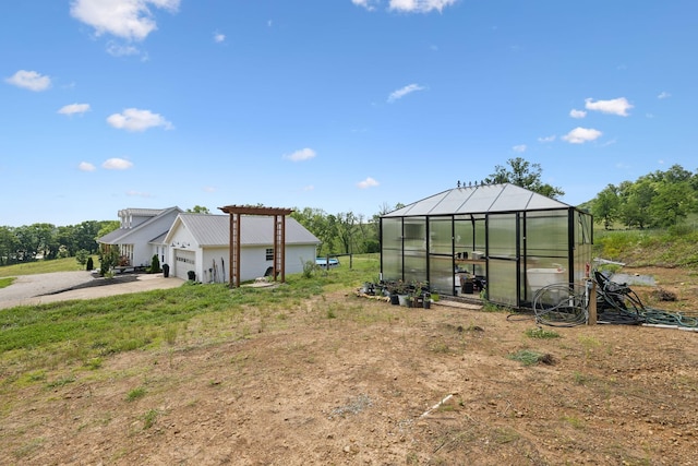 4588 Roy Thompson Rd, Mount Pleasant, TN 38474 - view of yard featuring a greenhouse, an outbuilding, driveway, and a garage