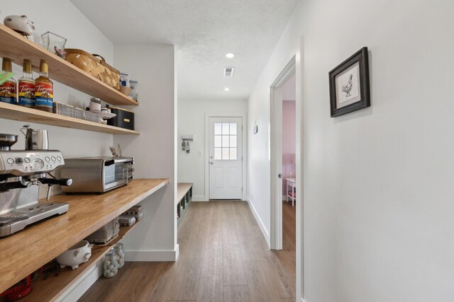 4588 Roy Thompson Rd, Mount Pleasant, TN 38474 - hall featuring wood finished floors, baseboards, a textured ceiling, and recessed lighting