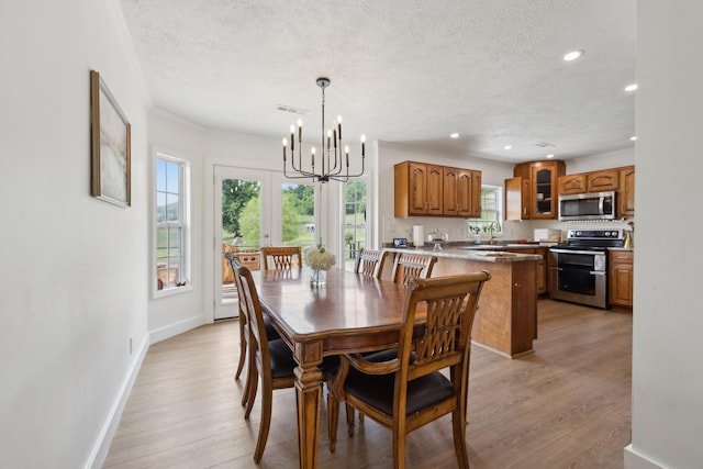 4588 Roy Thompson Rd, Mount Pleasant, TN 38474 - dining room with a textured ceiling, a chandelier, recessed lighting, light wood-type flooring, and baseboards
