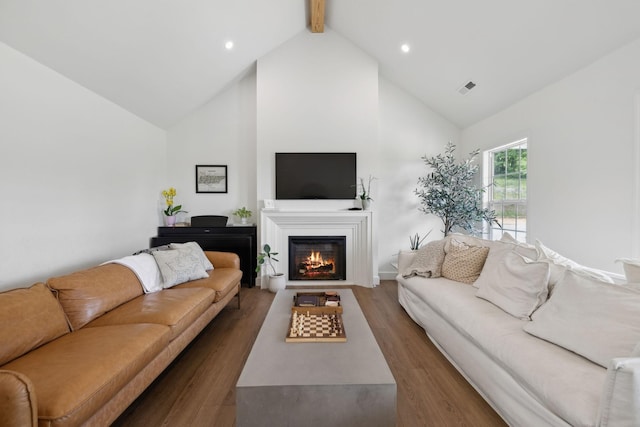4588 Roy Thompson Rd, Mount Pleasant, TN 38474 - living area with high vaulted ceiling, wood finished floors, a warm lit fireplace, beamed ceiling, and recessed lighting