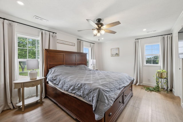 4588 Roy Thompson Rd, Mount Pleasant, TN 38474 - bedroom featuring multiple windows, light wood-type flooring, crown molding, and recessed lighting