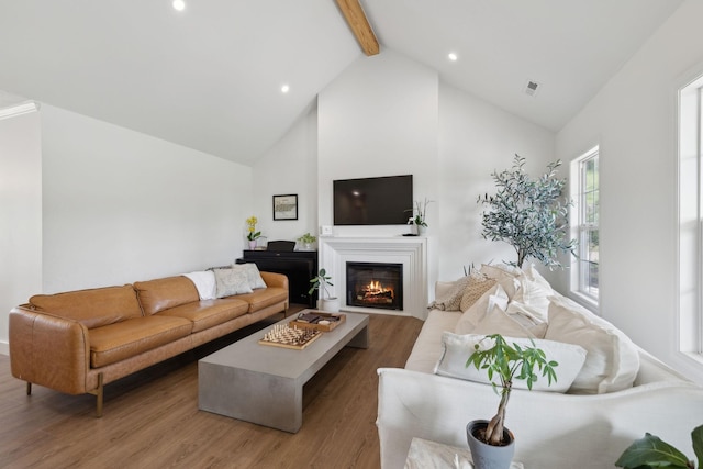 4588 Roy Thompson Rd, Mount Pleasant, TN 38474 - living area featuring high vaulted ceiling, beam ceiling, wood finished floors, a lit fireplace, and recessed lighting