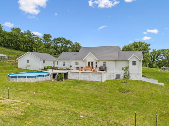 4588 Roy Thompson Rd, Mount Pleasant, TN 38474 - back of property with an outdoor pool, metal roof, cooling unit, and a wooden deck