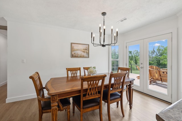 4588 Roy Thompson Rd, Mount Pleasant, TN 38474 - dining area featuring crown molding, a chandelier, light wood-style flooring, a textured ceiling, and french doors