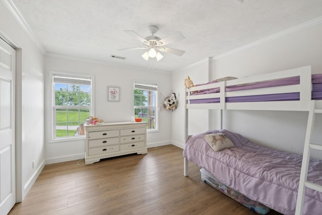 4588 Roy Thompson Rd, Mount Pleasant, TN 38474 - bedroom featuring a textured ceiling, wood finished floors, ornamental molding, baseboards, and ceiling fan