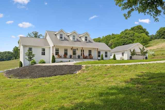 4588 Roy Thompson Rd, Mount Pleasant, TN 38474 - view of front of home featuring a porch, a front lawn, a detached garage, and metal roof