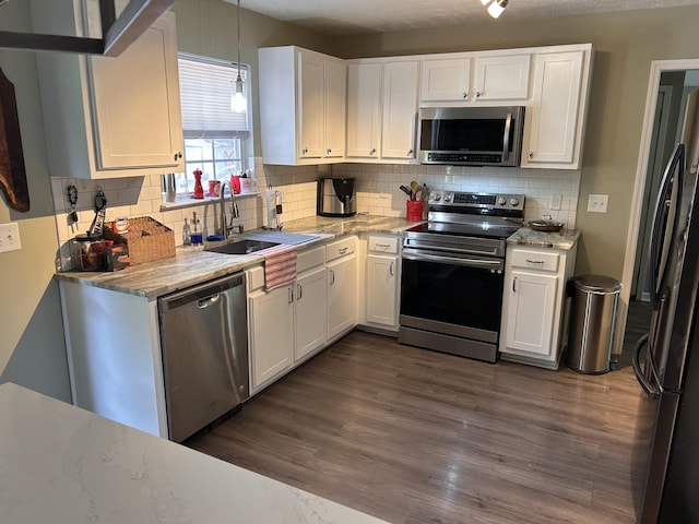 7324 Bermuda Dr, Christiana, TN 37037 - kitchen with appliances with stainless steel finishes, white cabinetry, dark wood finished floors, a sink, and tasteful backsplash